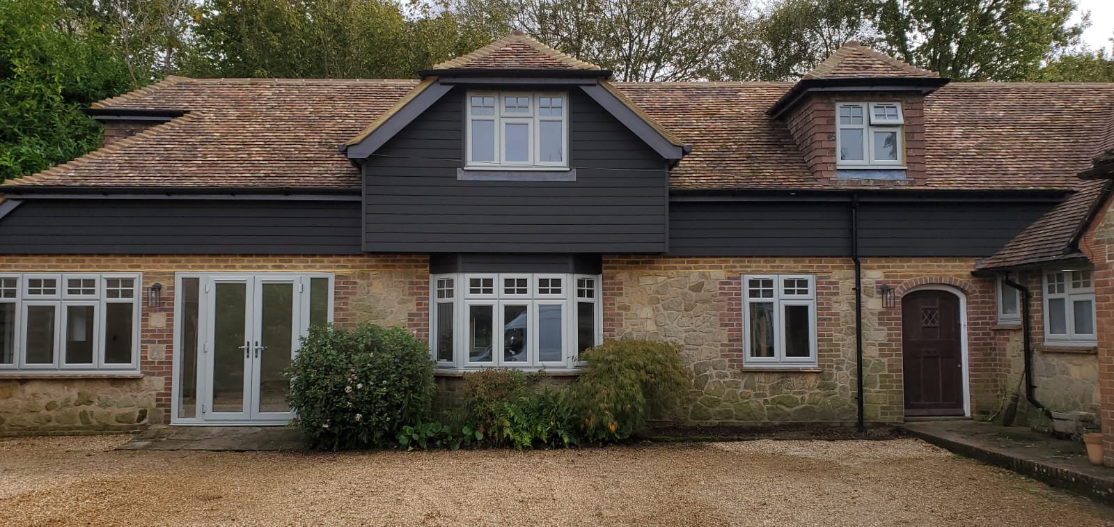 Large stone and brick country house with dormer windows undergoing renovation, West Sussex — JT Builds & Specialised Carpentry